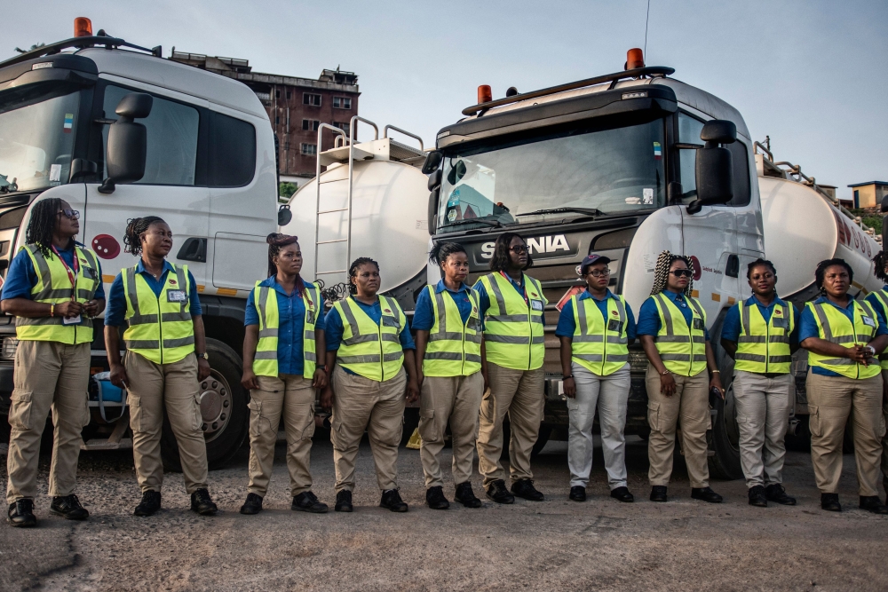 Female truck drivers stand at the Ladybird Logistics meeting point before the start of the workday in Takoradi, western Ghana, on April 3, 2019.  AFP / Cristina Aldehuela 