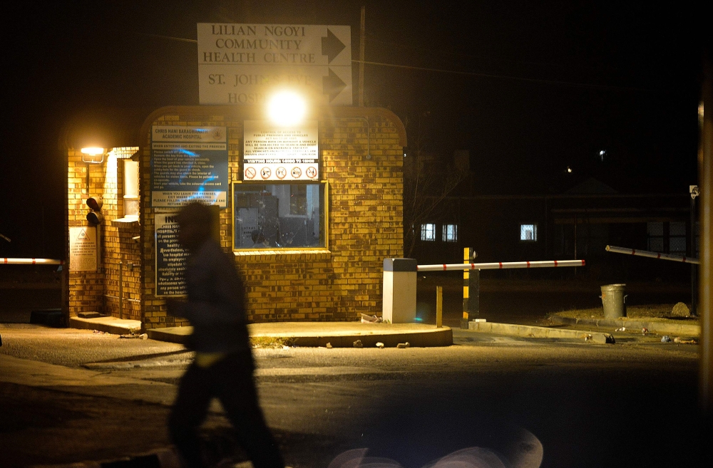 In this file photograph taken on April 24, 2014, a pedestrian walks by the community centre at the Chris Hani Baragwanath Hospital in the South African landmark township of Soweto. AFP/Mujahid Safodien