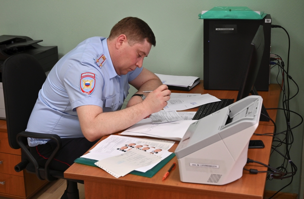 An official of a migration department under Russia's Interior Ministry receives and registers passport applications of Ukrainian separatist-controlled Donetsk and Luhansk Regions' residents, after Russia's President Vladimir Putin signed an order simplify