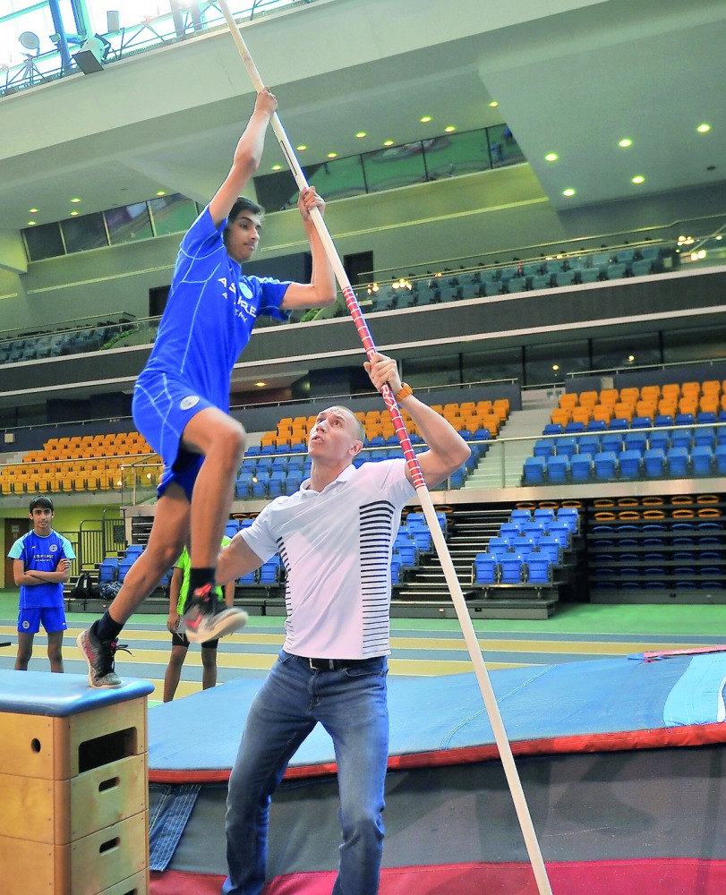 Piotr Lisek, pole vaulter gives some tips to an Aspire Academy student during a session at Aspire Academy yesterday.