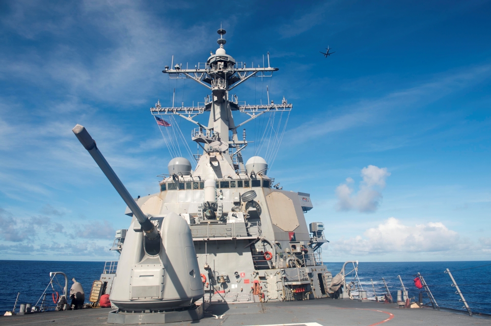 A P-8 Poseidon flies over the Arleigh Burke-class guided-missile destroyer USS Benfold (DDG 65) as part of information-gathering operations during Valiant Shield 2016 in the Philippine Sea September 16, 2016.  US Navy photo by Mass Communication Specialis