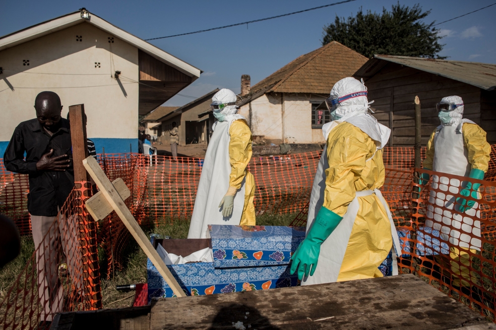 A family member of a deceased unconfirmed Ebola patient reacts inside an Ebola Treatment Centre run by The Alliance for International Medical Action on August 13, 2018 in Beni. AFP/John Wessels