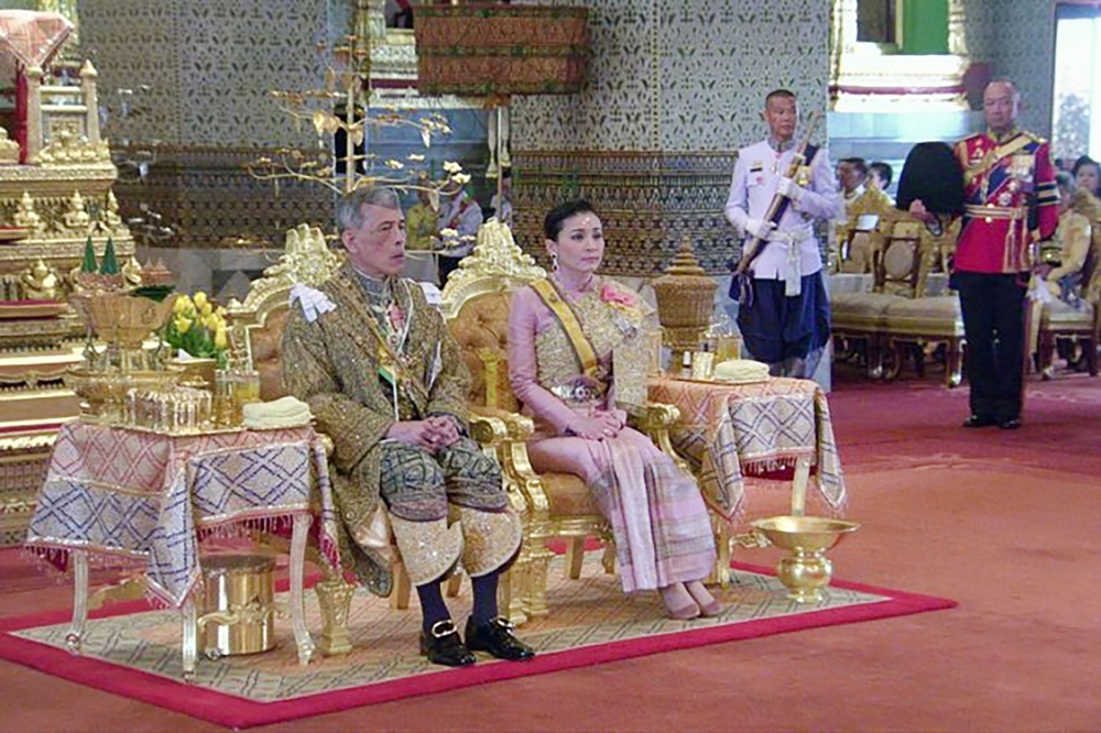  This framegrab handout from the Thai Royal Household Bureau taken and released on May 4, 2019 shows Thailand's King Maha Vajiralongkorn sitting beside Queen Suthida during his coronation in Bangkok. AFP PHOTO / THAI ROYAL HOUSEHOLD BUREAU