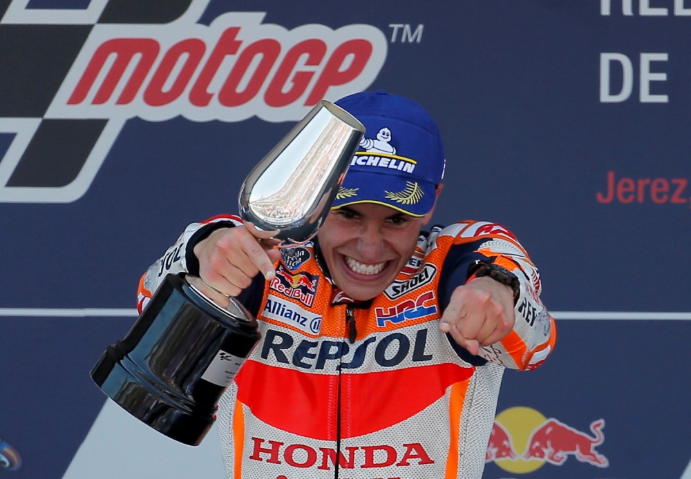 Repsol Honda Team's Marc Marquez celebrates on the podium with a trophy after winning the race REUTERS/Jon Nazca