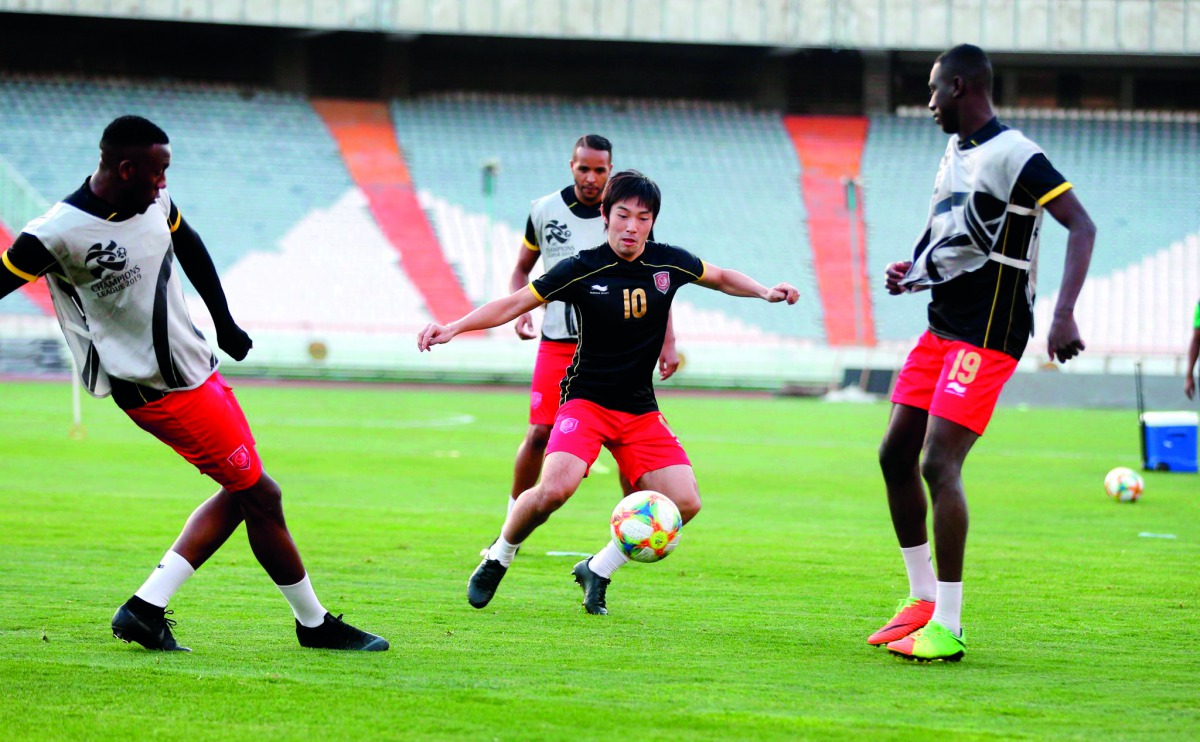 Al Duhail’s Japanese international player Shoya Nakajima passes the ball to team-mate Almoez Ali (right) during a training session held in Tehran, Iran, yesterday, ahead of today’s AFC Champions League Group C match against Esteghlal FC.  