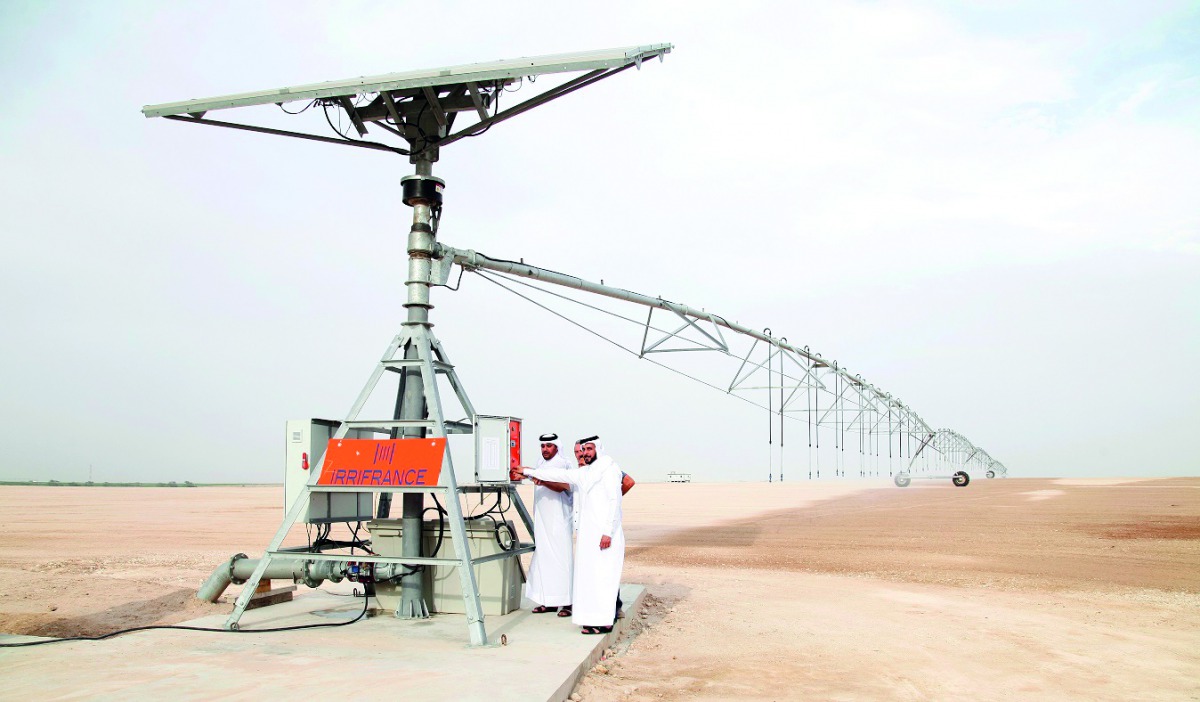 Senior officials switching on the first solar-powered irrigation system to be used for growing fodder.