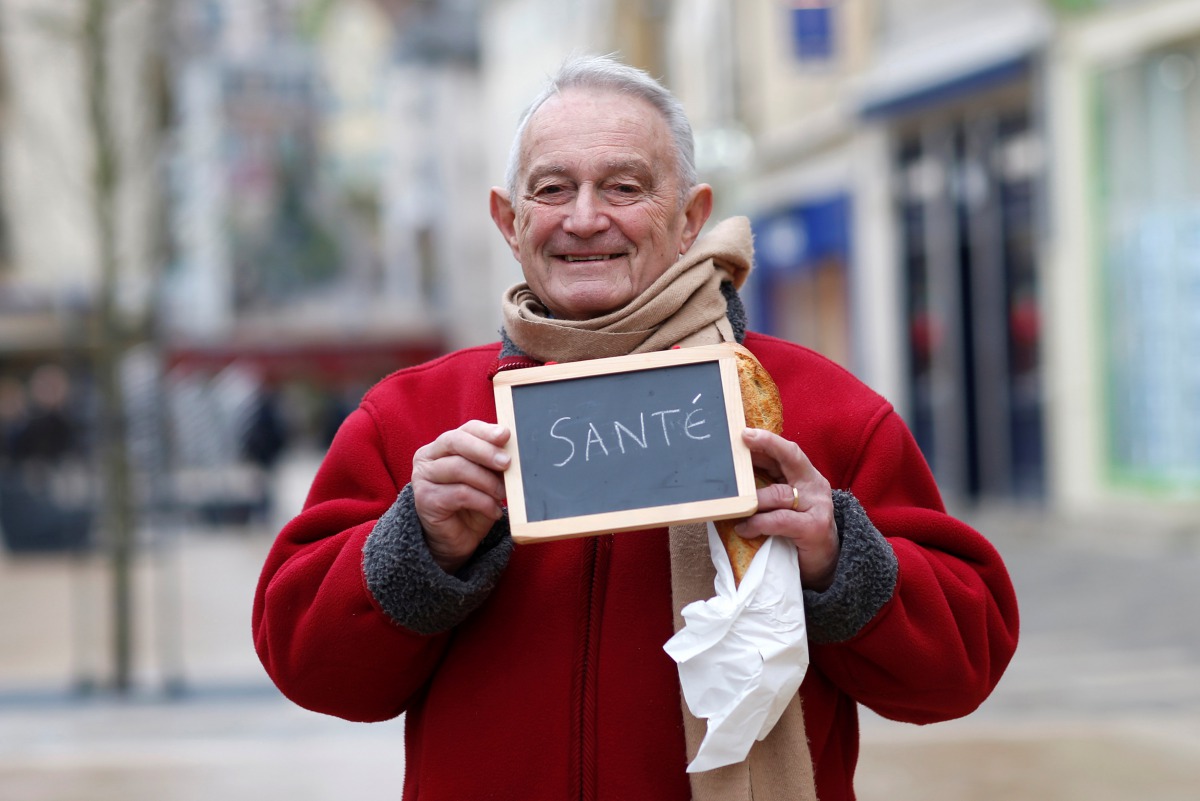 Representative image: (Francois Dore, 83,  holds a blackboard with the word health the most important election issue for him as he poses for Reuters in Chartres, France,  February 1, 2017.)  