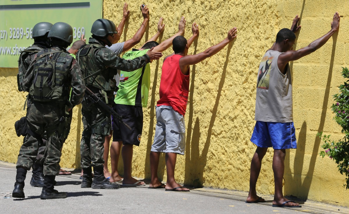 Army soldiers check people during a military police strike over wages while patrolling the streets of Vila Velha Espirito Santo, Brazil, February 11, 2017. Reuters/Paulo Whitaker