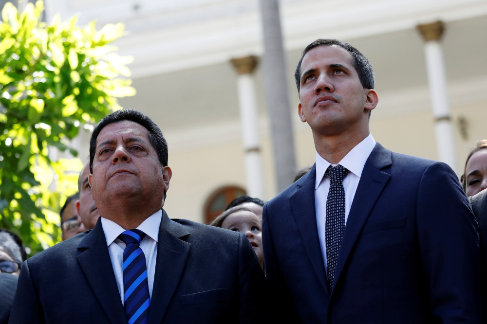 File photo of Juan Guaido (R), new President of the National Constituent Assembly and lawmaker of the Venezuelan opposition party Popular Will (Partido Voluntad Popular), and lawmaker Edgar Zambrano of Democratic Action party (Accion Democratica), leave t