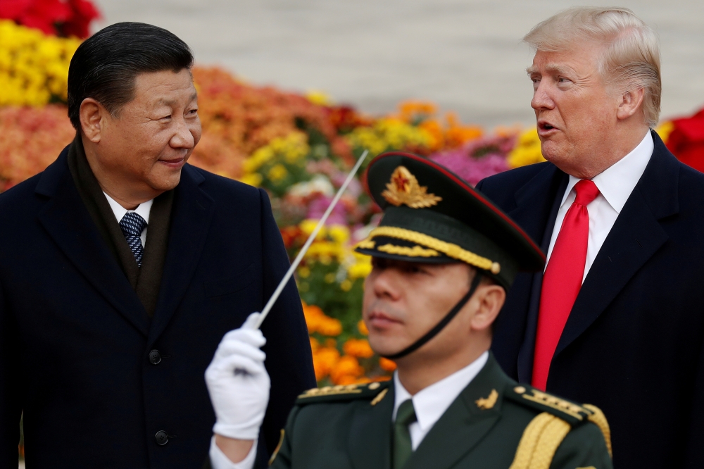 FILE PHOTO: U.S. President Donald Trump takes part in a welcoming ceremony with China's President Xi Jinping at the Great Hall of the People in Beijing, China, November 9, 2017. REUTERS/Damir Sagolj