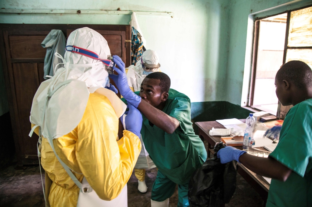 Health workers wear protective equipment as they prepare to attend to suspected Ebola patients at Bikoro Hospital in the Democratic Republic of Congo on May 12, 2018. AFP / UNICEF / Mark Naftalin