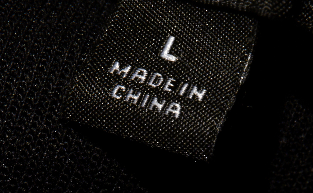 A photo illustration shows a label inside an item of clothing reading 