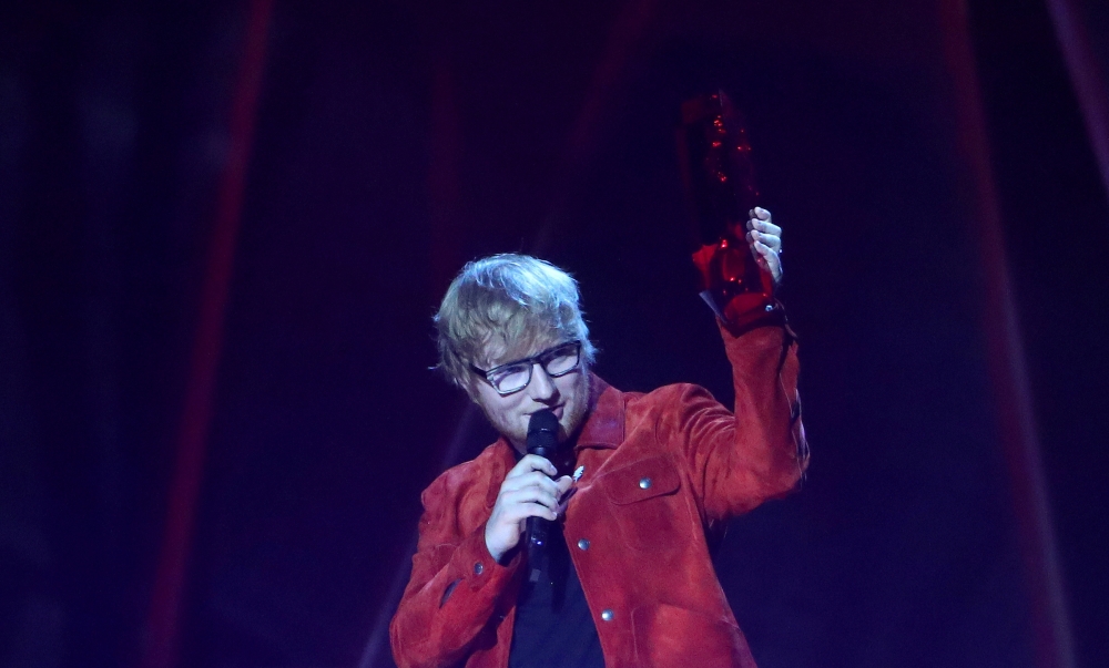 FILE PHOTO: Ed Sheeran accepts the award for global success at the Brit Awards at the O2 Arena in London, Britain, February 21, 2018. REUTERS/Hannah McKay/File Photo