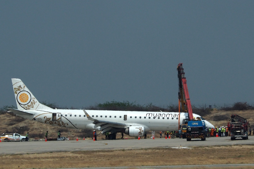 A general view shows a Myanmar National Airlines passenger plane after an emergency landing at Mandalay international airport on May 12, 2019. AFP / STR
