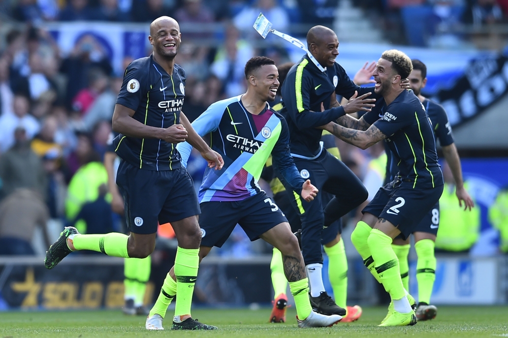 (L-R) Manchester City's Belgian defender Vincent Kompany, Brazilian striker Gabriel Jesus, Brazilian midfielder Fernandinho, English defender Kyle Walker celebrate at the final whistle of the English Premier League football match between Brighton and Hove