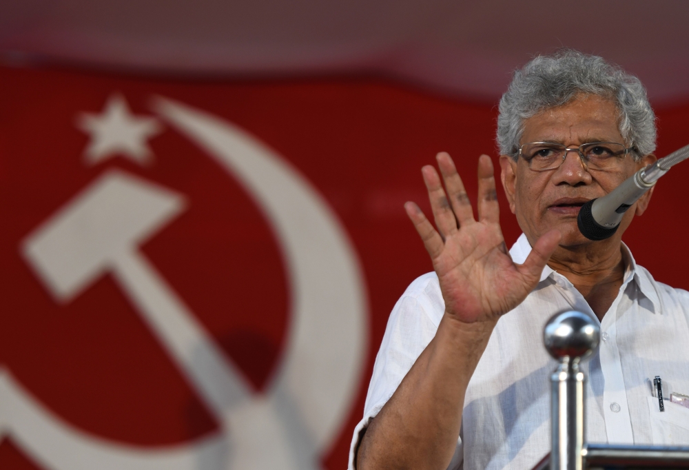 In this photo taken on April 19, 2019, Sitaram Yechury, leader of the Communist Party of India (Marxist), gestures to supporters at an election campaign rally in Perambra in the south Indian state of Kerala. AFP/Arun Sankar