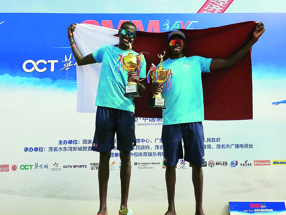 Qatar’s Ahmed Tijan (right) and Cherif Younousse pose with their trophies after winning the 2019 Asian Senior Beach Volleyball Championships final against hosts China in Maoming, yesterday. 