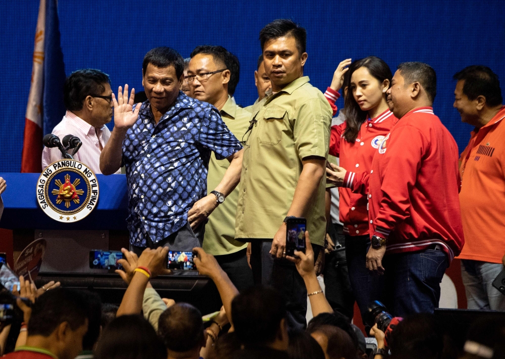 Philippine President Rodrigo Duterte waves to his supporters as he attends the Partido Demokratiko Pilipino-Lakas Bayan (PDP-LABAN) meeting in Manila on May 11, 2019 after endorsing the political party's senatorial candidates / AFP / Noel CELIS
 