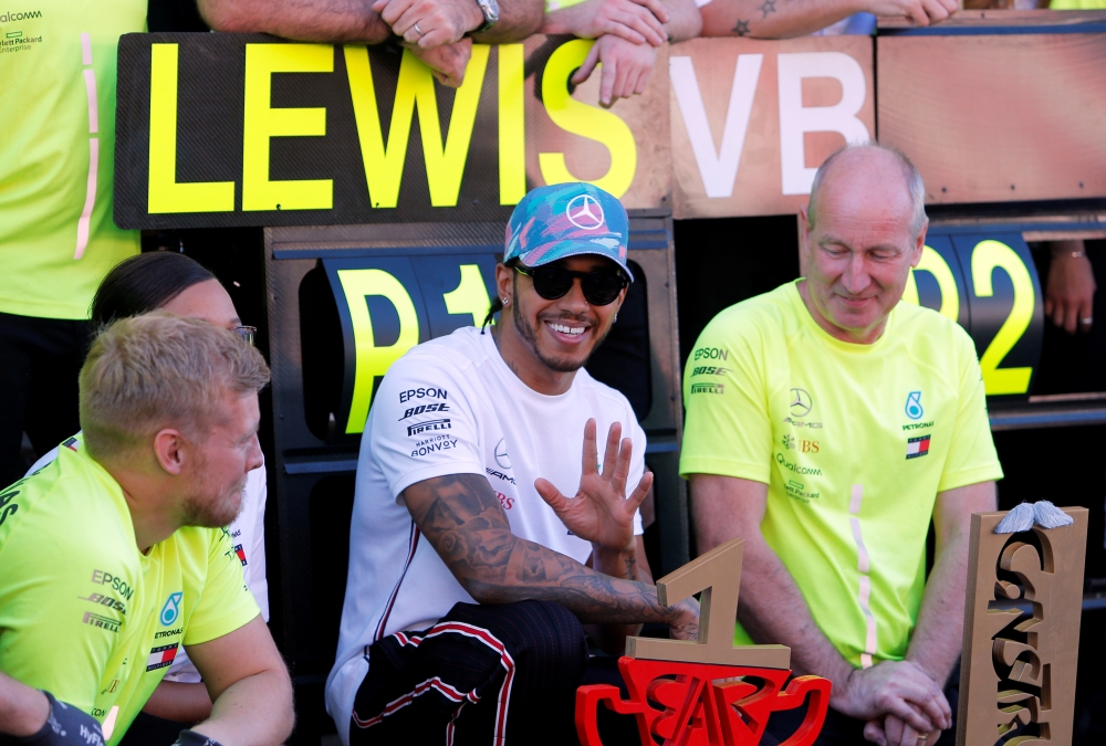 Mercedes' Lewis Hamilton celebrates with his team after victory. (REUTERS/Jon Nazca)