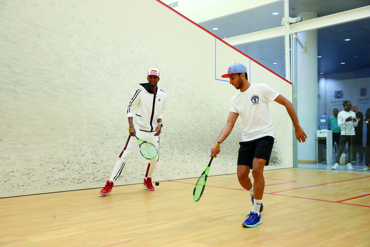 Qatar’s Abdulla Al Tamimi (right) and world champion in high jump Mutaz Barsim of Qatar play squash during the opening ceremony of Al Tamimi’s ATA Sports Academy.