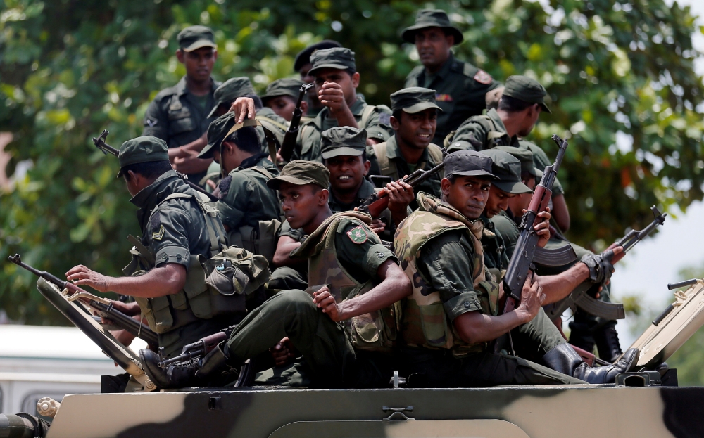 Sri Lankan soldiers patrol a road of Hettipola on top of an armored vehicle, after a mob attack in a mosque in the nearby village of Kottampitiya, Sri Lanka May 14, 2019. REUTERS/Dinuka Liyanawatte
