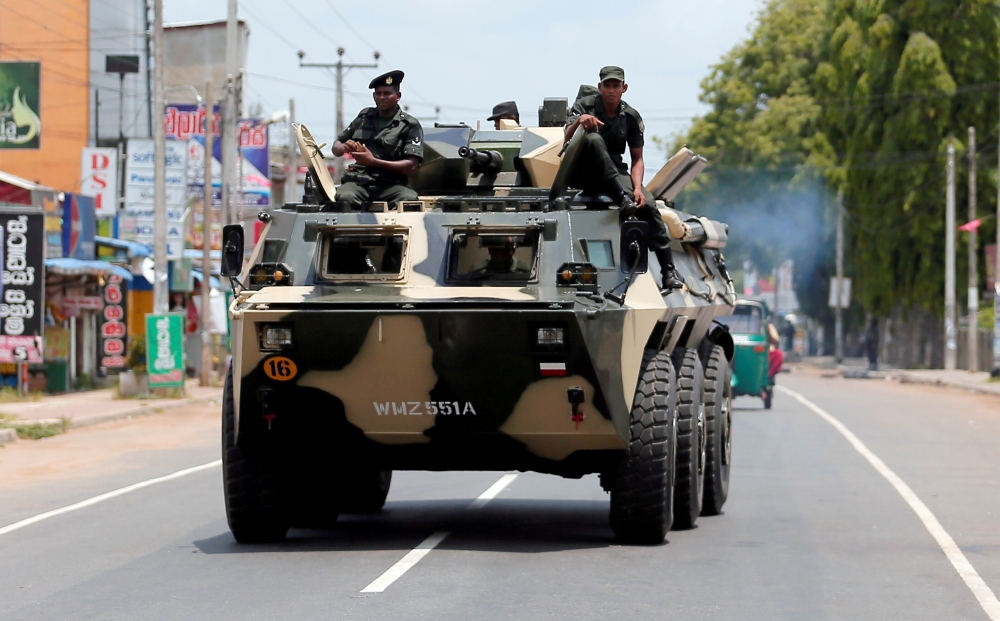 Sri Lankan soldiers patrol a road of Hettipola after a mob attack in a mosque in the nearby village of Kottampitiya, Sri Lanka May 14, 2019. REUTERS/Dinuka Liyanawatte