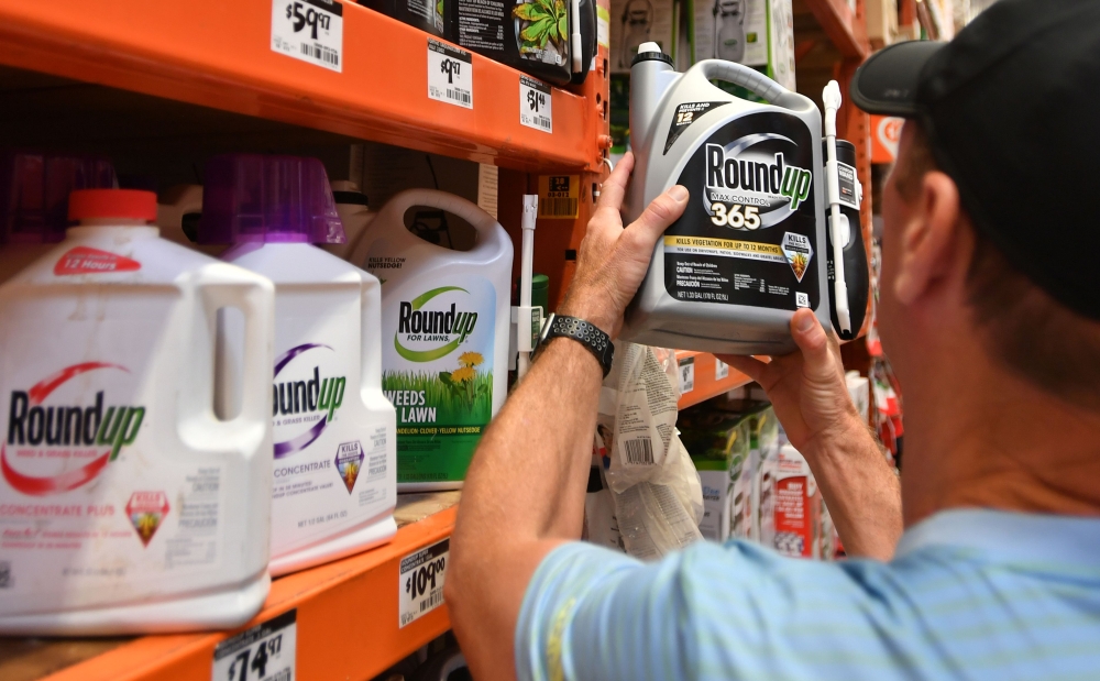 In this file photo taken on July 9, 2018, Customer Gary Harms shops for Roundup products at a store in San Rafael, California.  AFP / Josh Edelson 