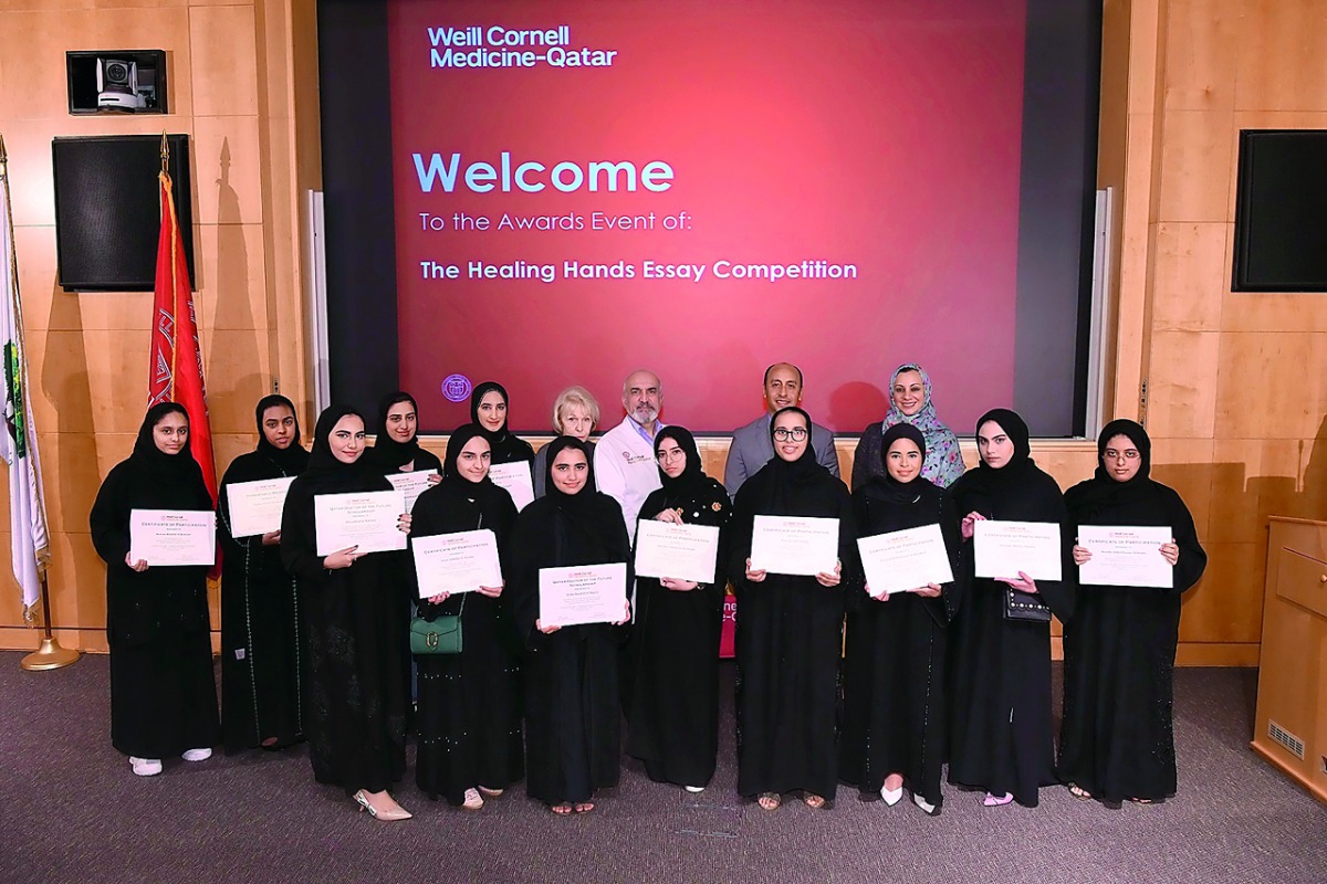 The winners of the essay competition pose for a group photo.