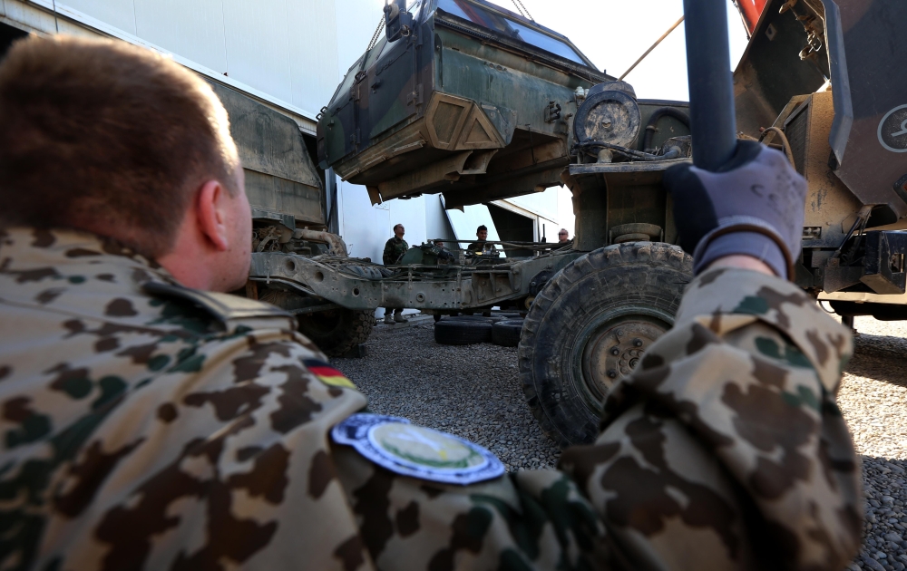 FILE PHOTO: German military experts work on an army vehicle at a workshop for Peshmerga forces in Erbil. AFP / SAFIN HAMED
