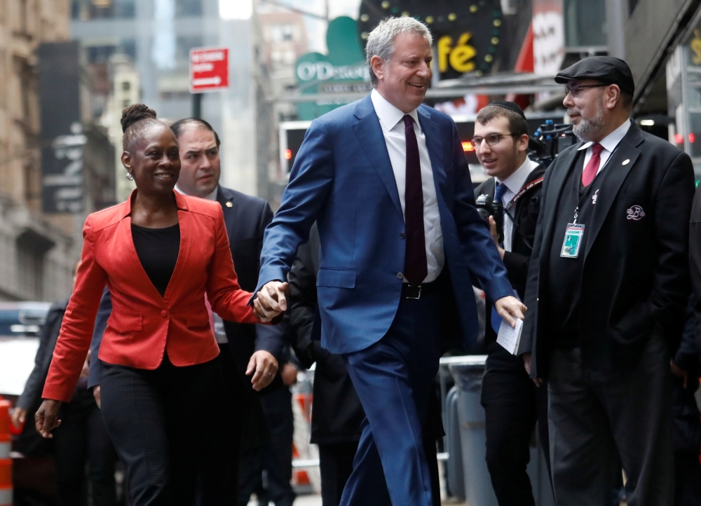 New York City Mayor Bill de Blasio and his wife Chirlane McCray, after announcing de Blasio's candidacy for the Democratic presidential nomination with a central campaign message, arrive at the Good Morning America show in New York City, U.S., May 16, 201