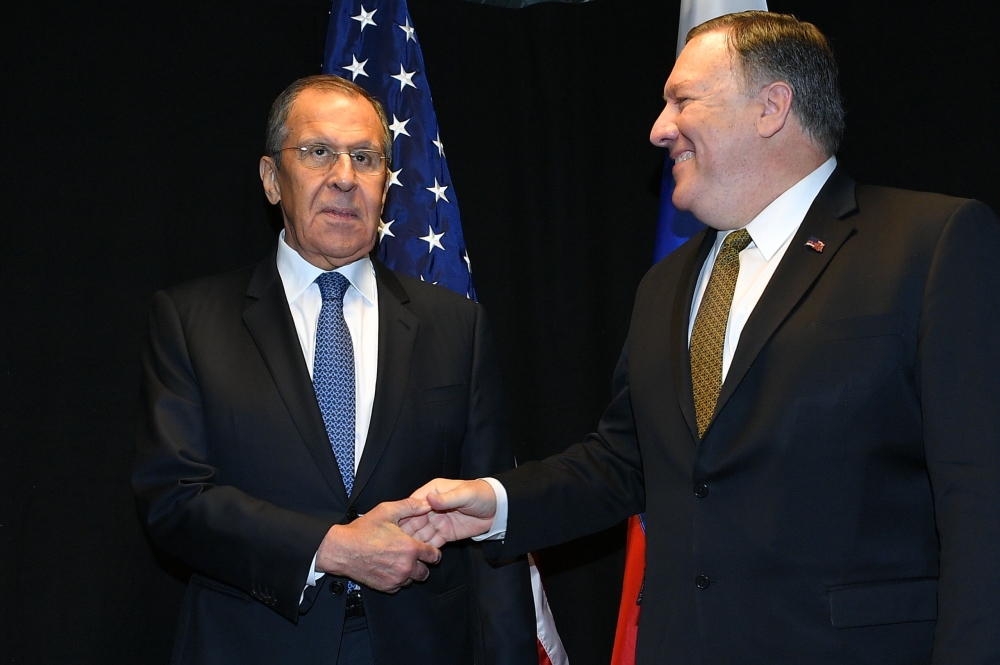 In this file photo taken on May 6, 2019, US Secretary of State Mike Pompeo (R) shakes hands with Russia's Foreign Minister Sergei Lavrov as they meet on the sidelines of the Arctic Council Ministerial Meeting in Rovaniemi, Finland. / AFP / POOL / MANDEL N