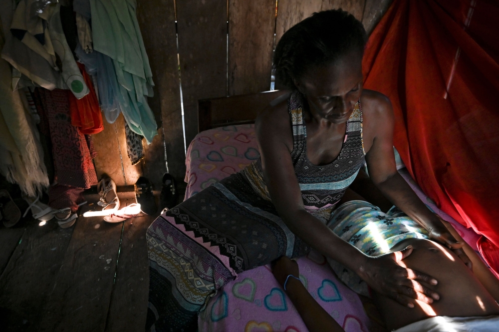 Colombian midwife Marciana Caycedo checks a pregnant woman in Isla Mono, in the San Juan river, Choco department, Colombia, on April 23, 2019.  AFP / Raul Arboleda
 