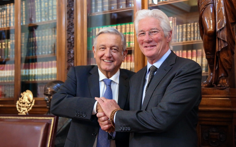 Handout picture released by the Mexican presidency showing Mexican President Andres Manuel Lopez Obrador (L) shaking hands with US actor Richard Gere after a private meeting at the Palacio Nacional in Mexico City on May 14, 2019. 