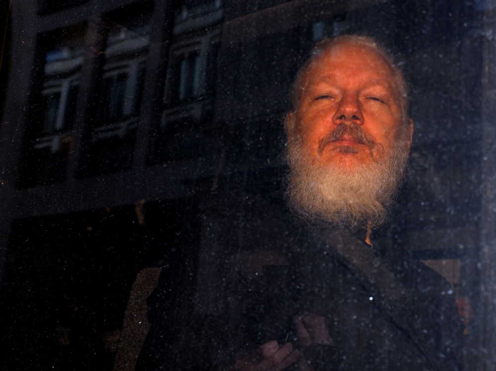 FILE PHOTO: WikiLeaks founder Julian Assange is seen as he leaves a police station in London, Britain April 11, 2019. REUTERS/Peter Nicholls