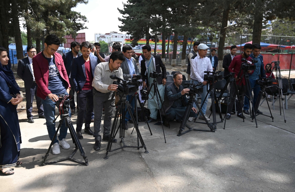 Afghan journalists gather during a news report at the Shahr-e-Naw Park in Kabul on April 30, 2019. AFP / Wakil Kohsar