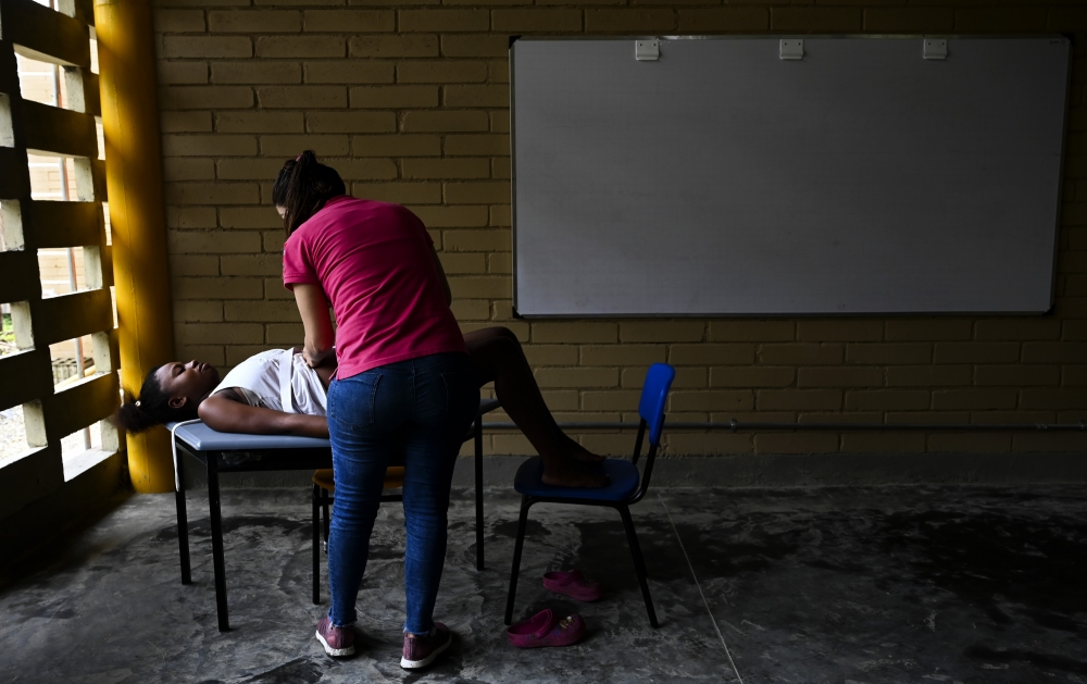 REPRESENTATIVE IMAGE:  Colombian medical doctor of the San Raffaele hospital ship, Durley Maya, checks a pregnant woman at a classroom improvised as office in Isla Mono, in the San Juan river, Choco department, Colombia, on April 23, 2019.  AFP / Raul Arb