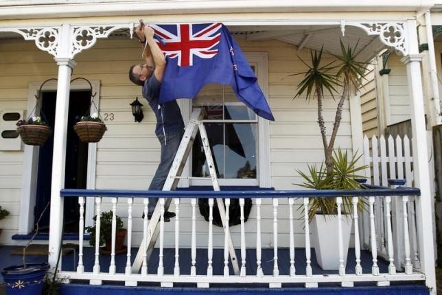 New Zealand All Blacks fan Brett Plumer nails a national flag to his house in Auckland September 9, 2011 ahead of the Rugby World Cup opening match. Reuters