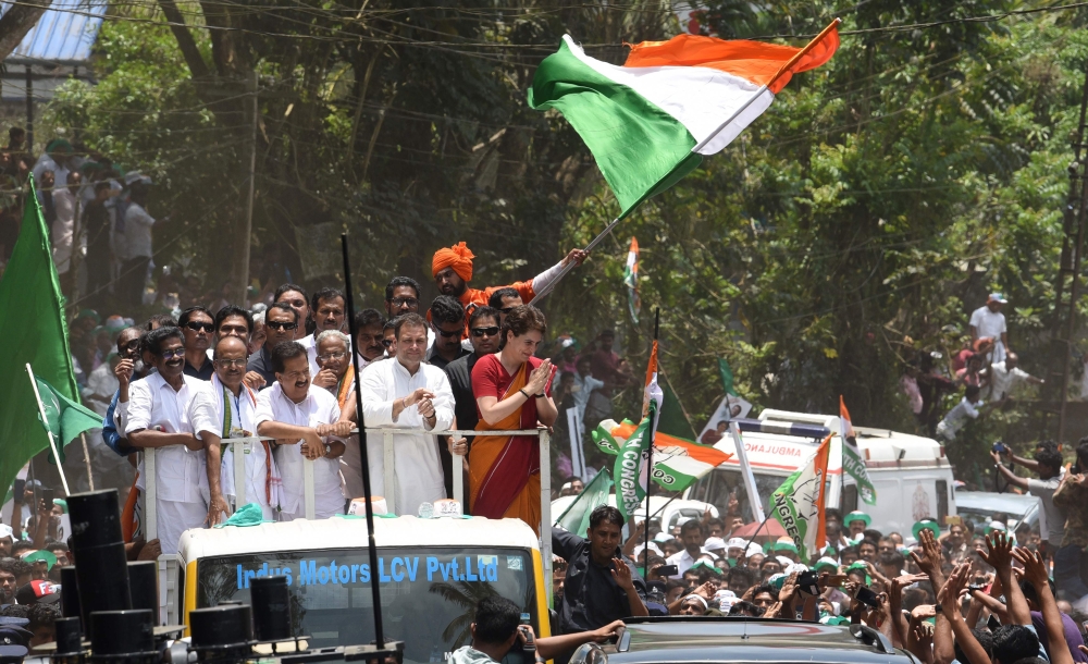 FILE PHOTO: Indian National Congress Party president Rahul Gandhi (C) and Priyanka Gandhi Vadra (centre R) gesture to supporters on Rahul's visit to file his candidacy nomination in Kalpetta town in the Wayanad region of southern Kerala state.  AFP / STR