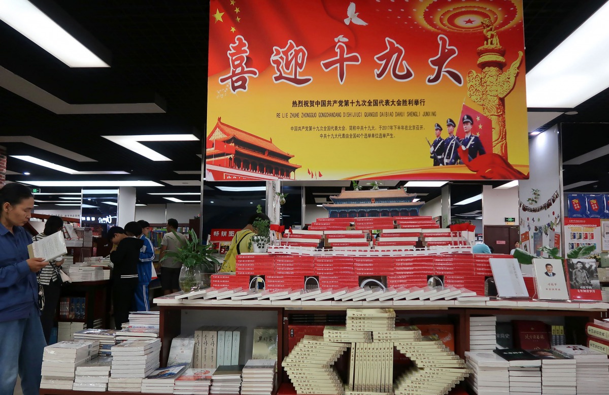 Books named 'Xi Jinping: Seven Years of Educated Youth' piled up as the Tiananmen Rostrum in China's northern Hebei province on September 24, 2017. (AFP) 