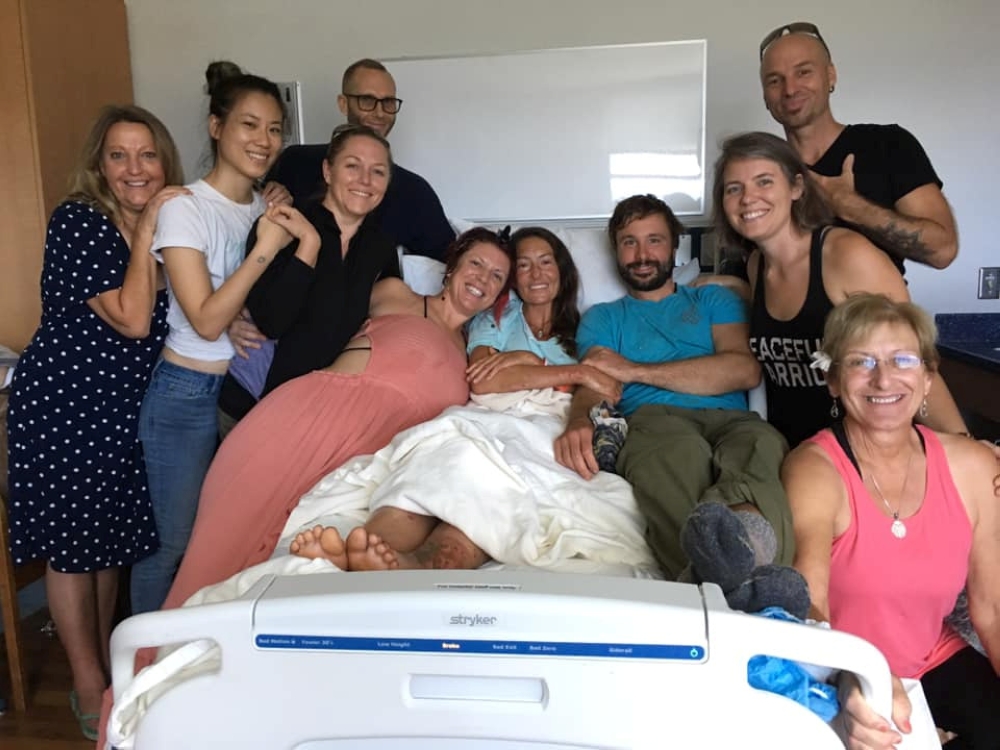 Amanda Eller, a yoga instructor who went missing for 17 days while hiking in Maui's Makawao Forest Reserve, poses for a photo from her hospital bed with her peers at Maui Memorial Medical Center in Hawaii, U.S., after she was rescued during a search opera