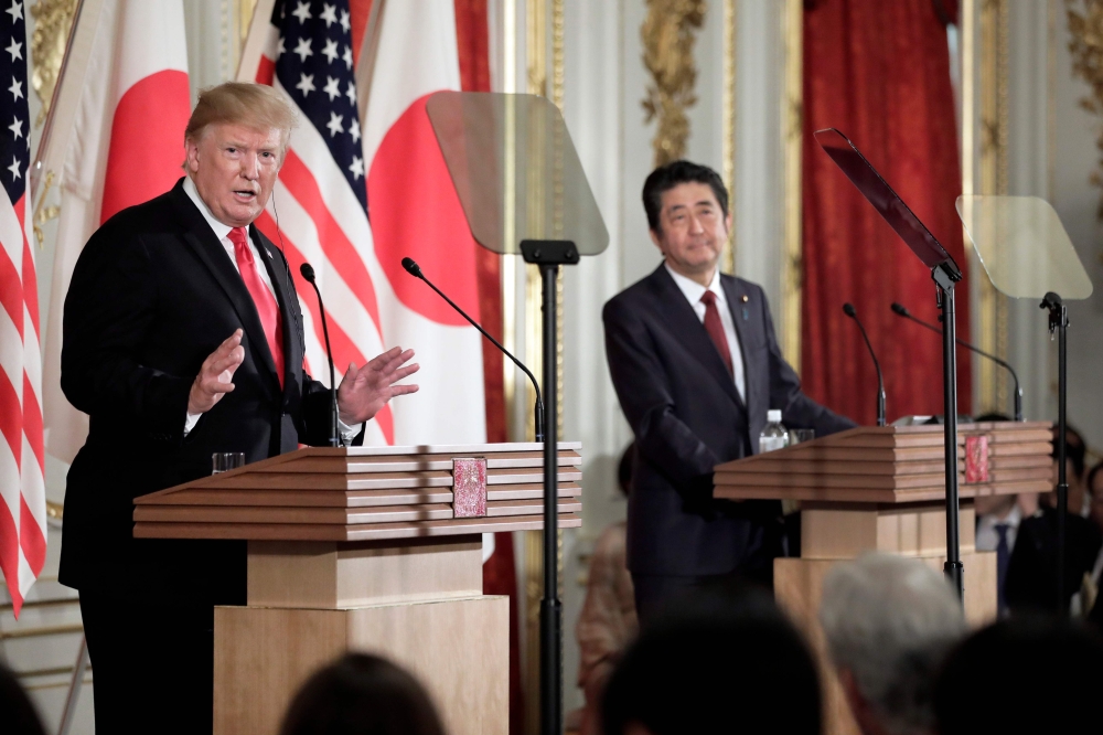 US President Donald Trump (L) speaks during a joint press conference with Japan's Prime Minister Shinzo Abe at Akasaka Palace in Tokyo on May 27, 2019. / AFP / POOL / Kiyoshi Ota