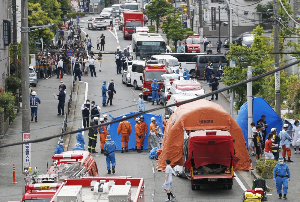 Rescue workers and police officers operate at the site where sixteen people were injured in a suspected stabbing by a man, in Kawasaki, Japan May 28, 2019 in this photo released by Kyodo. Kyodo/via REUTERS 