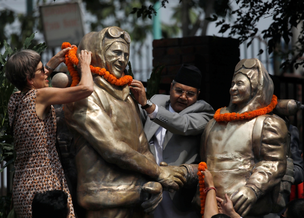 Minister for Information and Communication Technology Gokul Prasad Baskota along with the daughter of Edmund Hillary, Sarah Hillary offer garland to the statues of Edmund Hillary and Tenzing Norgay Sherpa, the first mountaineers to conquer Mount Everest i