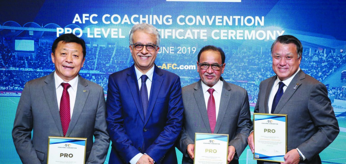 Saoud A Aziz M A Al Mohannadi, the Vice President of the Qatar Football Association poses for a picture along with Shaikh Salman bin Ebrahim Al Khalifa, the Asian Football Confederation President, Du Zhaocai, the Acting President of the Chinese FA and Koh