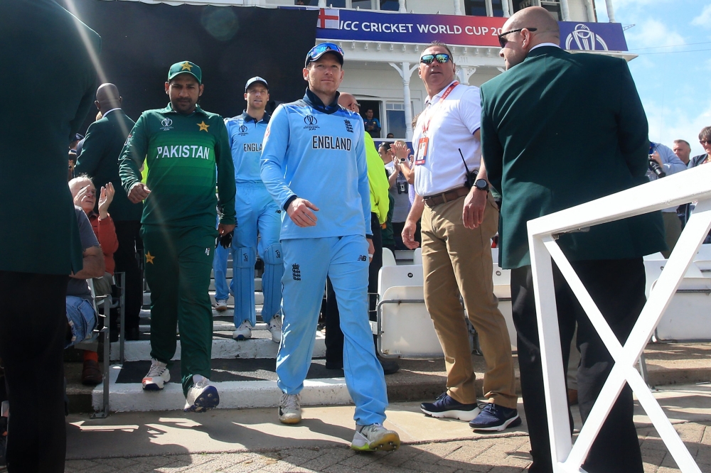 Pakistan's captain Sarfaraz Ahmed (L) and England's captain Eoin Morgan (C) lead their teams out ahead of the 2019 Cricket World Cup group stage match between England and Pakistan at Trent Bridge in Nottingham, central England, on June 3, 2019. AFP / Lind