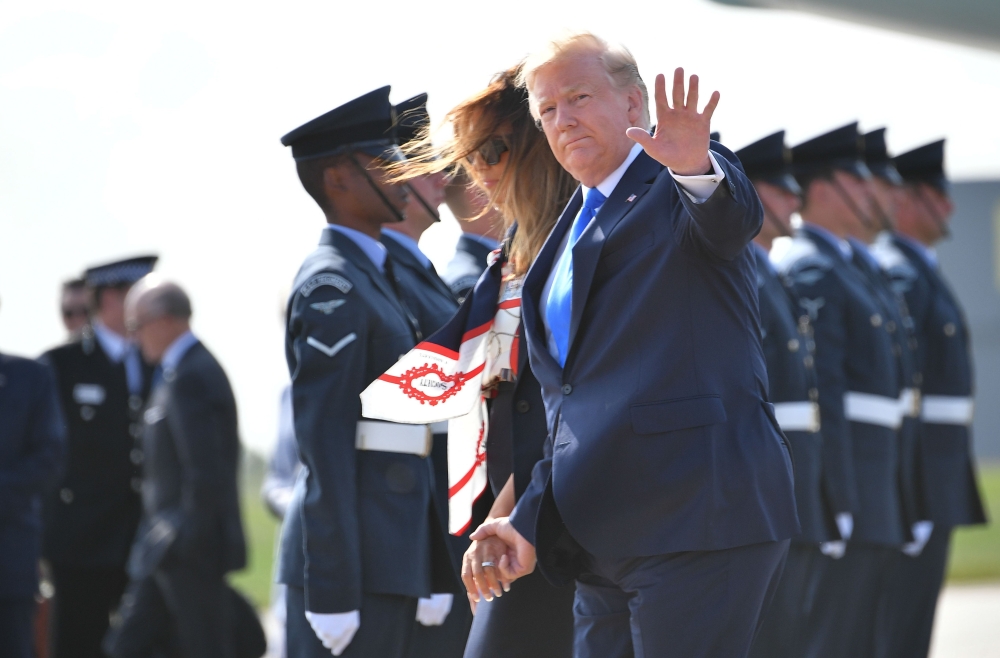 US President Donald Trump (R) and US First Lady Melania Trump (L) disembark Air Force One at Stansted Airport, north of London on June 3, 2019, as they begin a three-day State Visit to the UK.   AFP / MANDEL NGAN