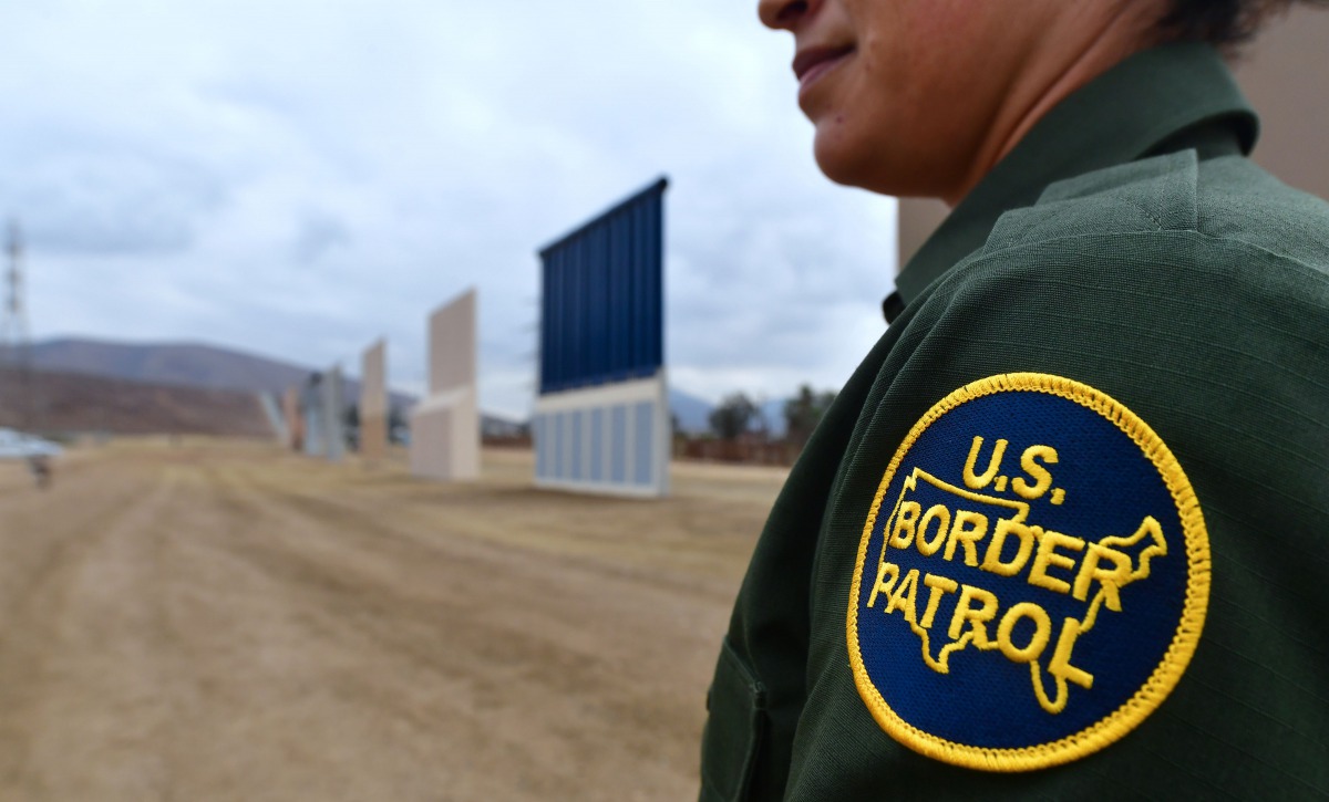 A US Border Patrol officer stands near prototypes of border wall proposed by US President Donald Trump on November 1, 2017 in San Diego, California. AFP/Frederic J Brown