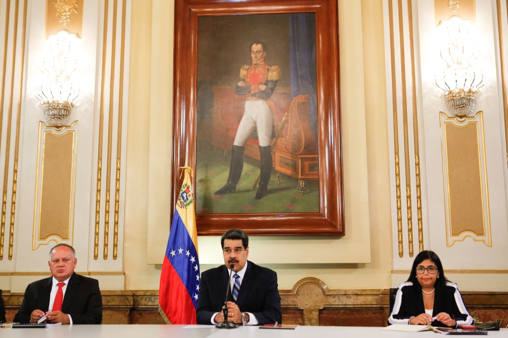 Venezuela's President Nicolas Maduro (C) delivering a speech next to Vice-president Delcy Rodriguez (R) and the President of the Constituent Assembly Diosdado Cabello (L) during a meeting with members of the National Defense Council at Miraflores Presiden