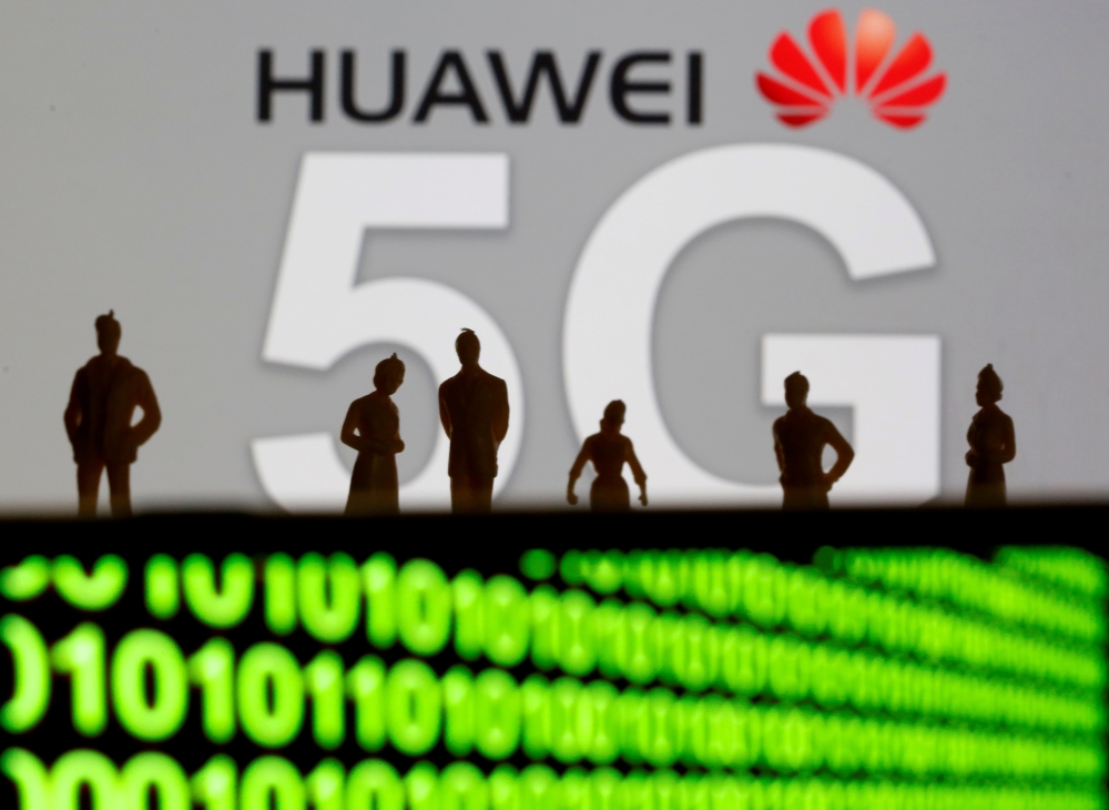 Small toy figures are seen in front of a displayed Huawei and 5G network logo in this illustration picture, March 30, 2019. Reuters/Dado Ruvic