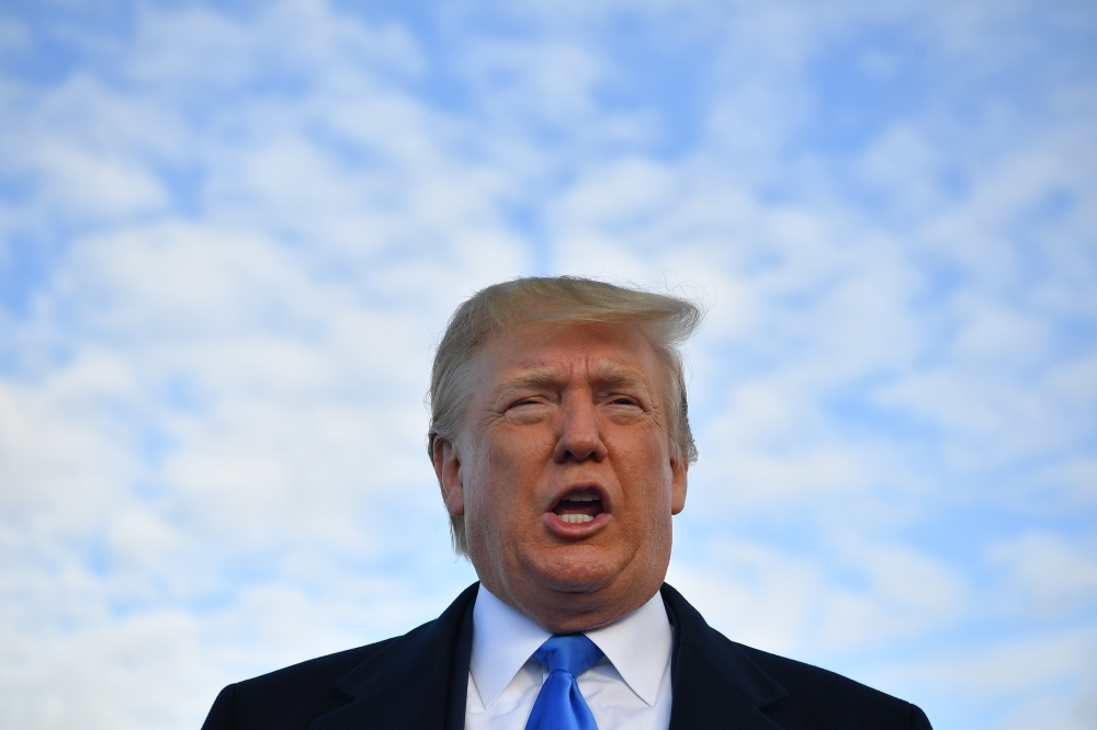 FILE PHOTO: US President Donald Trump speaks before boarding Air Force One at Shannon Airport in Shannon, Ireland, and fly to Normandy, France, to attend the 75th D-Day Anniversary.  AFP / MANDEL NGAN